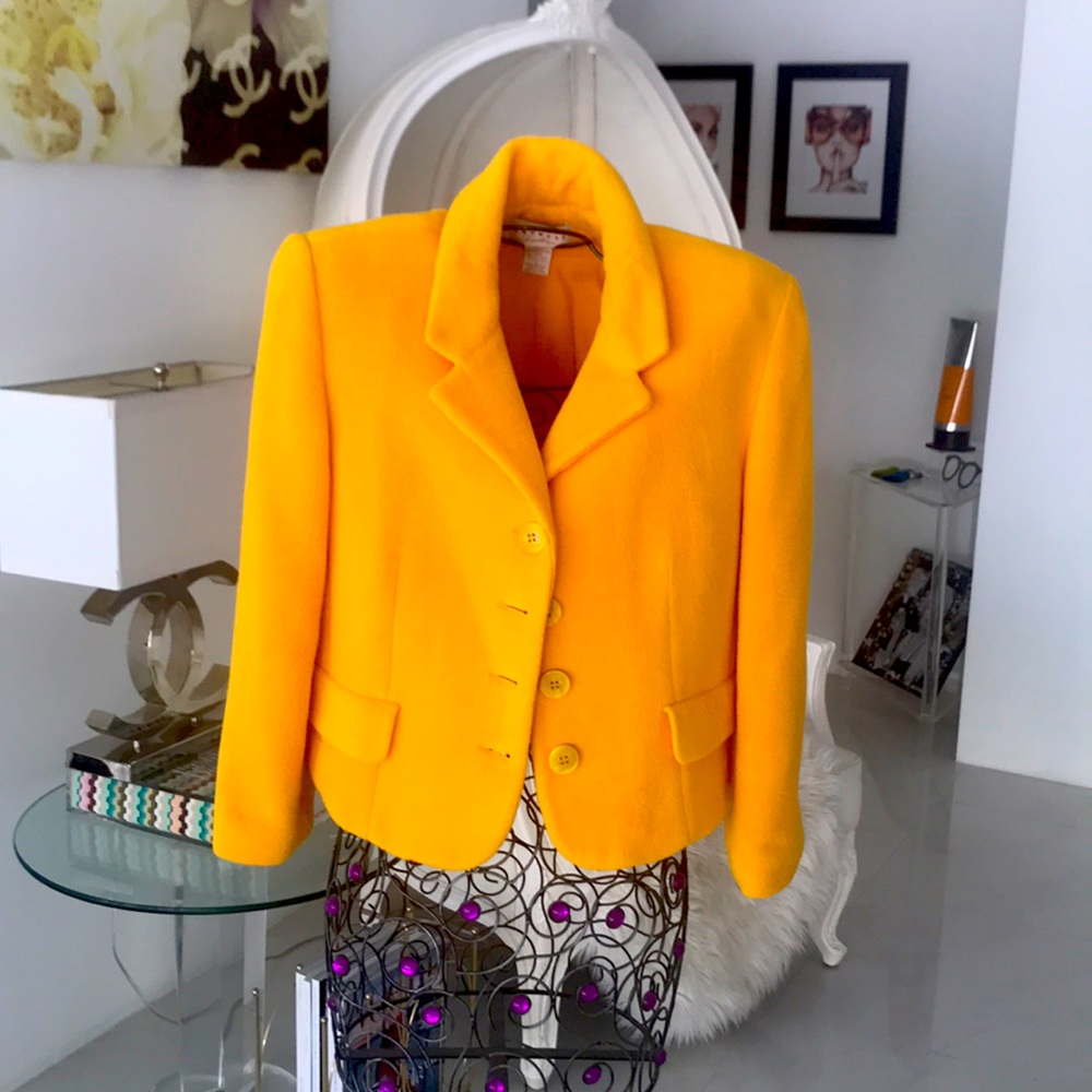 A waist length yellowish/ orange jacket.